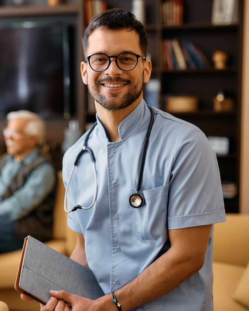 happy male nurse at residential care home looking 3SKYV67